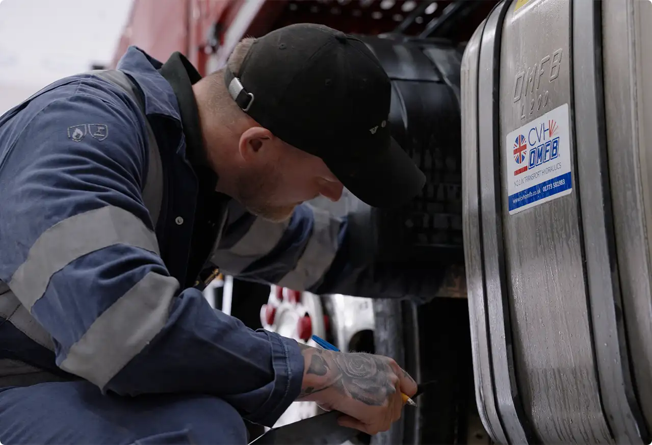 Maintenance man checking HGV tyres